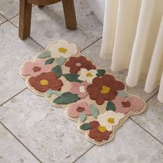 a bathroom rug with flowers on the floor