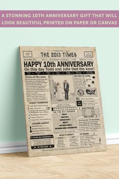 an old newspaper with the words happy 10th anniversary printed on it, next to a wooden floor