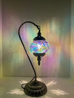 a lamp that is sitting in the middle of a room with light shining on it