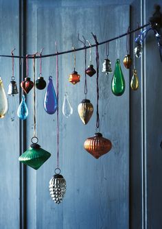 many different colored ornaments hanging from a line