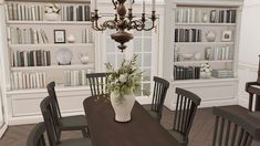 a dining room table with chairs and a vase filled with flowers