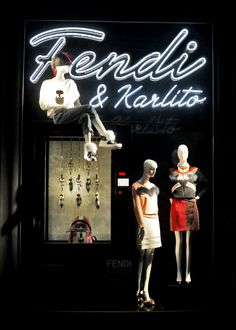 two mannequins in front of a store window display