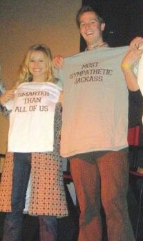 three people holding up t - shirts with words on them