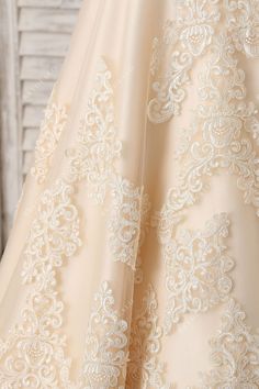 the back of a wedding dress with white lace on it