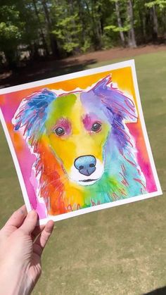 a person holding up a card with a colorful dog on it