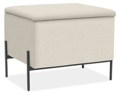 a small white ottoman with black legs