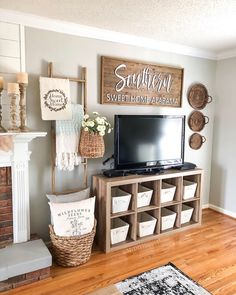 a television sitting on top of a wooden shelf in a living room next to a fire place