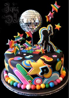 a birthday cake with the number 705 on it and colorful decorations, including a disco ball