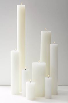 many white candles are lined up together