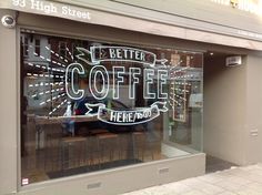 the window of a coffee shop that has lettering on it