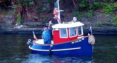 a red, white and blue boat with an american flag on the top is in the water