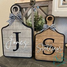 two wooden tags with the letters j and g on them