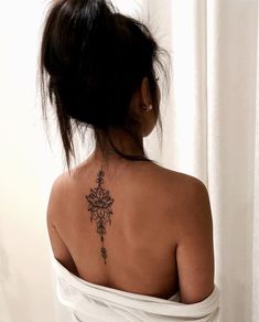 a woman with a flower tattoo on her back