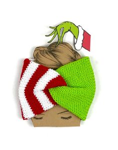 a knitted headband with a green and white hat on top