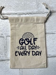 a golf bag hanging on a wall with the words golf all day every day printed on it