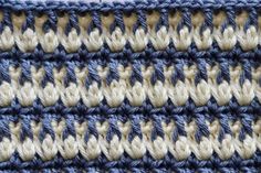 crocheted blue, white and beige fabric with vertical stripes