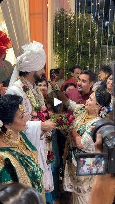 the bride and groom are being photographed by their guests in this wedding photo taken with a video camera