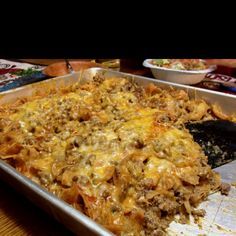 a casserole dish with meat and cheese in it