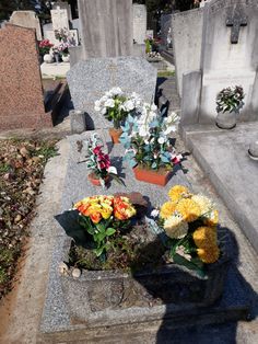 many flowers are placed on the headstones