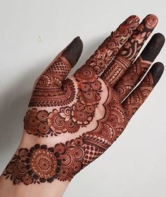 a hand that has some henna on it