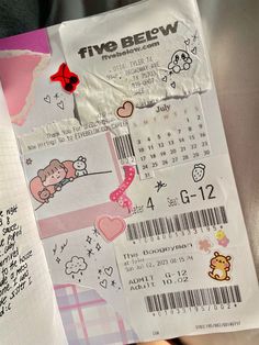 a person holding a paper with some stickers on it