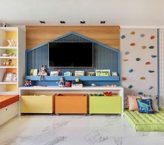 a child's playroom with colorful furniture and decor on the walls, along with a large flat screen tv