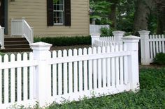 a white picket fence in front of a house