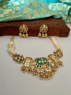 Gorgeous Mintgreen Kundan Choker Set that is trending and a bestseller!  Radiate splendour in this fusion set delicately handcrafted for you. The beautiful elephant design is a showstopper.  The set includes a choker necklace strung in tiny white beads and a pair of studs.  Details: Necklace Width at Centre-2.25 Inches Earrings Length-2.75 Inches Weight of Each Earring-12 gms All products are manufactured using traditional skills from our rich heritage of crafts.  The process of these crafts is essentially manual. Hence, any irregularities or variations are an inherent part of these handcrafting processes. Kundan Choker Set, Beautiful Elephant, Kundan Necklace Set, Kundan Choker, Cocktail Set, Bollywood Jewelry, Kundan Necklace, Kundan Earrings, Choker Set