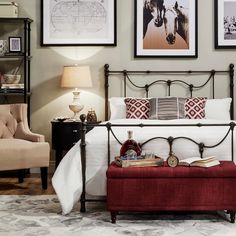 a bedroom with pictures on the wall above the bed