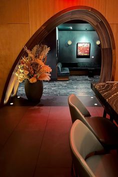 Framed arch doorway with botanical planter separating the teal lounge from the bar and restaurant at 53 in New York City.