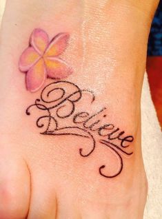 a foot with a flower on it and the word believe written in cursive writing