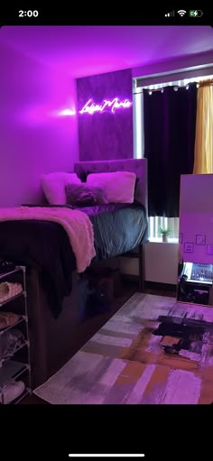 a bedroom with purple lighting and a bed