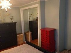 a room with a dresser and mirror in it