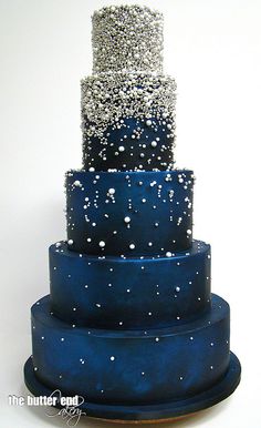 a three tiered blue cake with stars on it