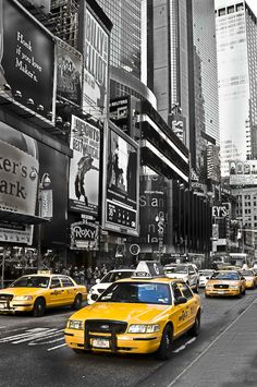 black and white photograph of taxi cabs in times square, new york city ny