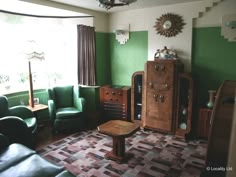 a living room filled with furniture and green walls