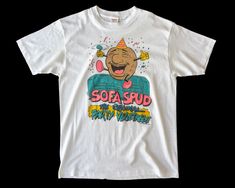 1980's vintage Sofa Spud t-shirt. Based on our hand measurements, the recommended modern unisex size for this garment is MEDIUM. HOWEVER, you should review the garment's actual measurements provided in the photos prior to purchasing. To ensure correct fit, we recommend comparing those measurements with the measurements of a similar garment in your closet. Fitted Vintage T-shirt With Funny Print, Vintage Short Sleeve T-shirt With Funny Print, Vintage Cotton T-shirt With Character Print, White Vintage T-shirt With Cartoon Print, Retro Cotton T-shirt With Cartoon Print, Vintage Camaro, Random Vintage, Hand Measurements, Animal Sweatshirt