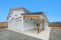 a large white building with two garages on top of it