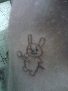 a small drawing of a rabbit on the back of someone's arm and leg