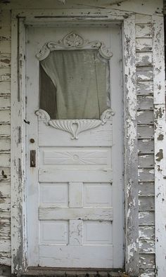 an old door with a curtain on it