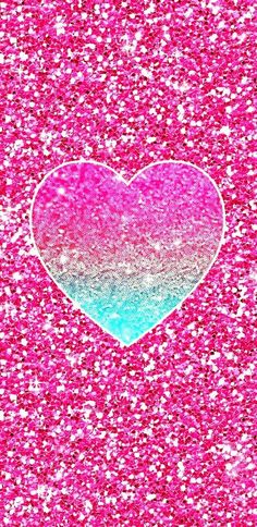 a pink and blue heart with glitter in the middle on a bright pink background photo