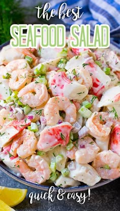 a bowl filled with shrimp salad next to lemon wedges