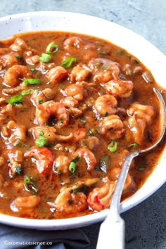 a white bowl filled with shrimp and sauce