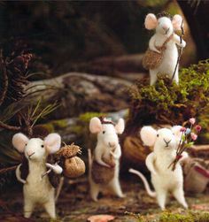 four little mice are standing in the woods