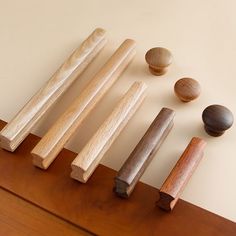 five wooden dowks lined up on top of a wood floor next to each other