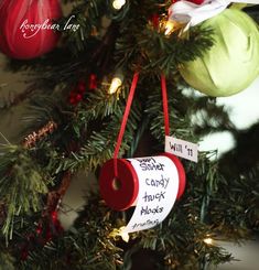 a christmas tree with ornaments hanging from it's branches and an ornament that says will it candy truck blocks?