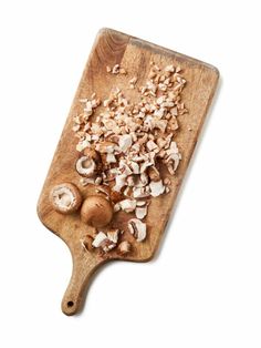 mushrooms on a wooden cutting board with white background