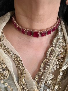 A symbol of feminism and elegance. Prepare yourself for the festive season with this Ruby CZ Choker Set with Earrings. Be it a gift, cocktail night or wedding reception this piece will add charm to your personality. Product Details: Material: Each piece is meticulously handcrafted from high-quality brass, CZ Stones. Necklace Dimensions: Weight: 45 grams. Closure Type: Premium Dori Adjustable Size: Yes  Earring Dimensions (Per Pair): Weight: 18 grams Length: 4 cm Width: 1.8 cm Closure Type: Push Plated Fine Jewelry For Party, Elegant Gold-plated Jewelry For Party, Elegant Gold Plated Jewelry For Party, Gold Plated Jewelry For Party, Glamorous Rose Gold Necklaces For Party, Glamorous Rose Gold Party Necklace, Sterling Silver Jewelry With Plating For Party, Diamond Round Jewelry For Parties, Diamond Dangle Jewelry For Celebration