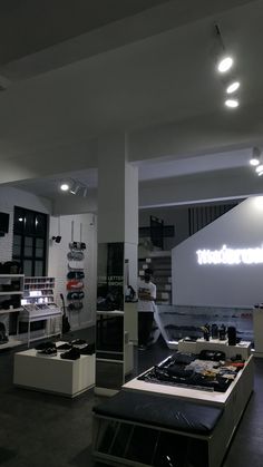 the interior of a shoe store with shoes on display