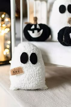 three white and black stuffed animals sitting on top of a bed next to each other